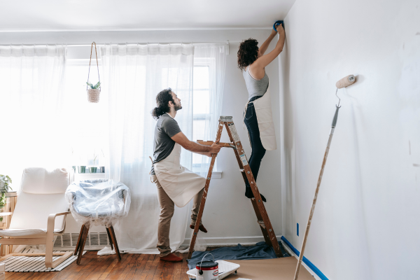 Couple prepping a room to be painted