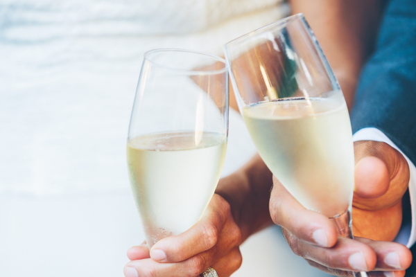 Couple holding two champagne glasses