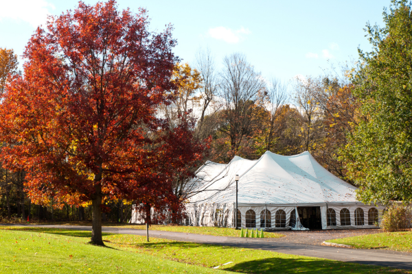 White party tent set up outdoors on a clear day